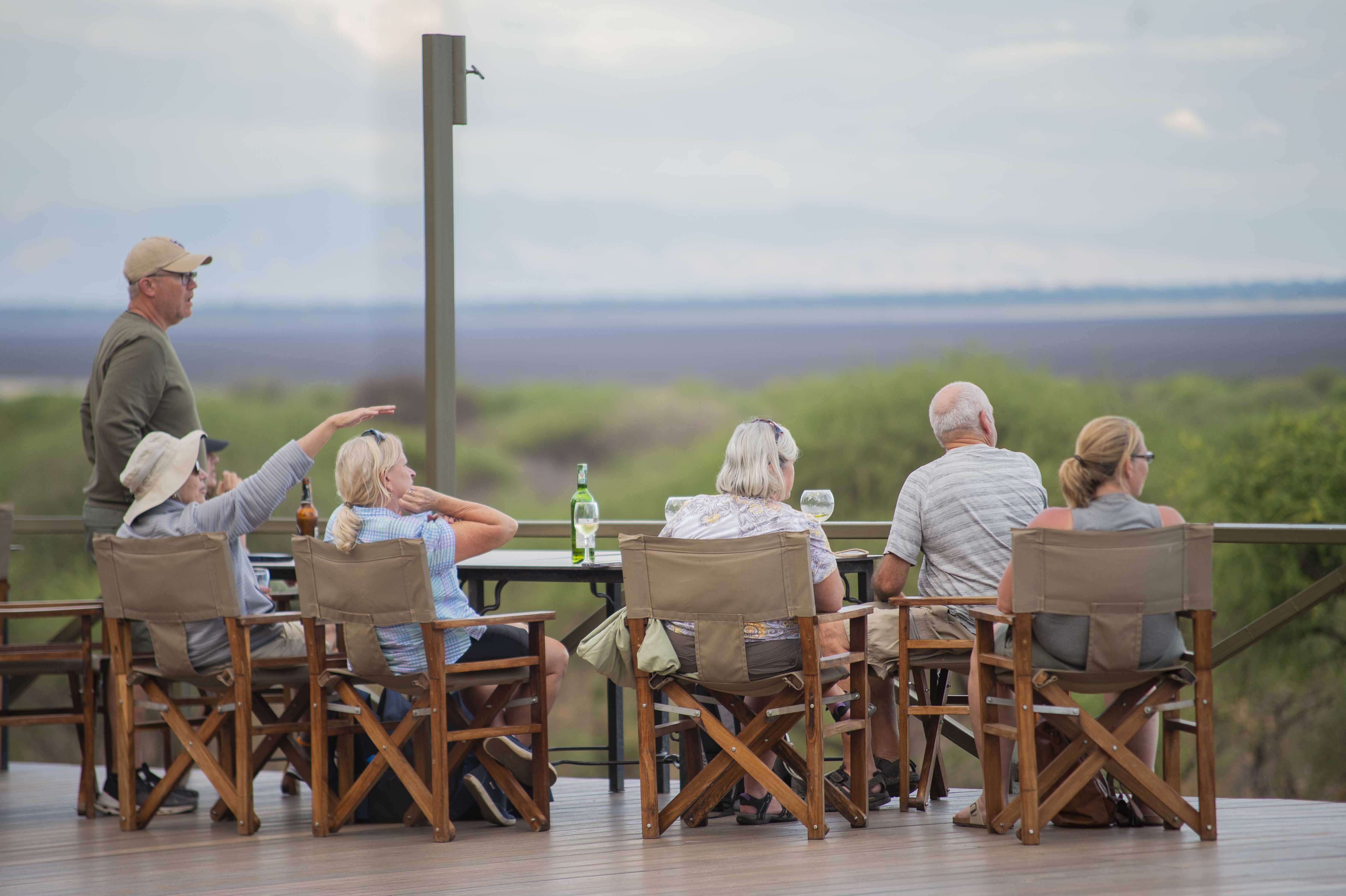 Senior safari guests relaxing on a lodge veranda in Tanzania