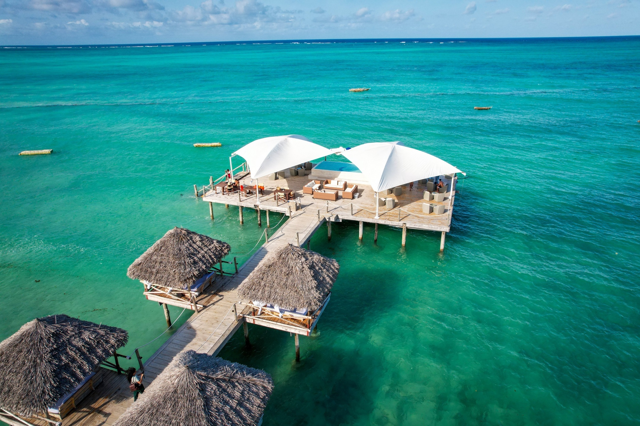 Aerial view of a white-sand beach and clear Indian Ocean water in Zanzibar