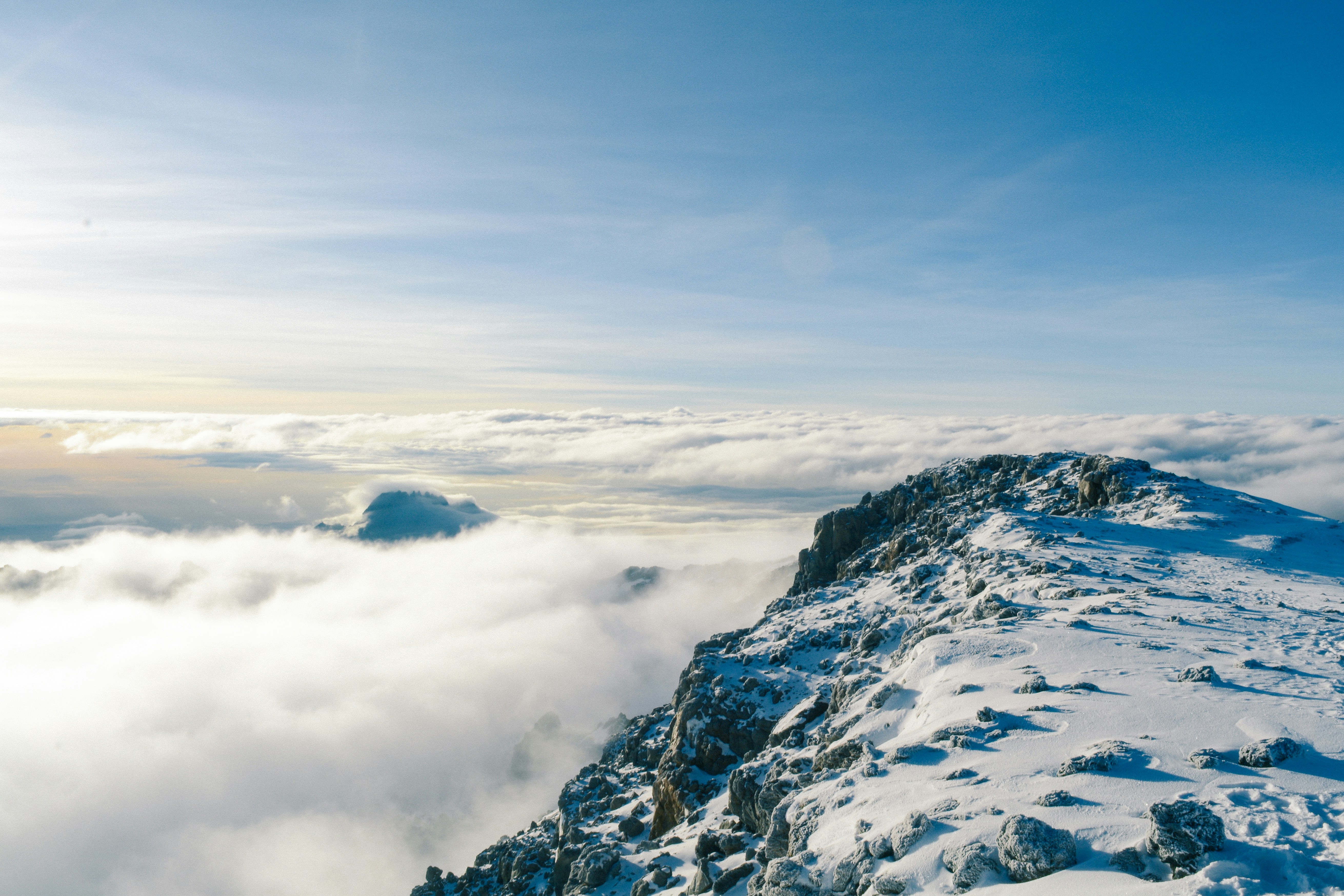 Snow-covered Kilimanjaro summit above the clouds