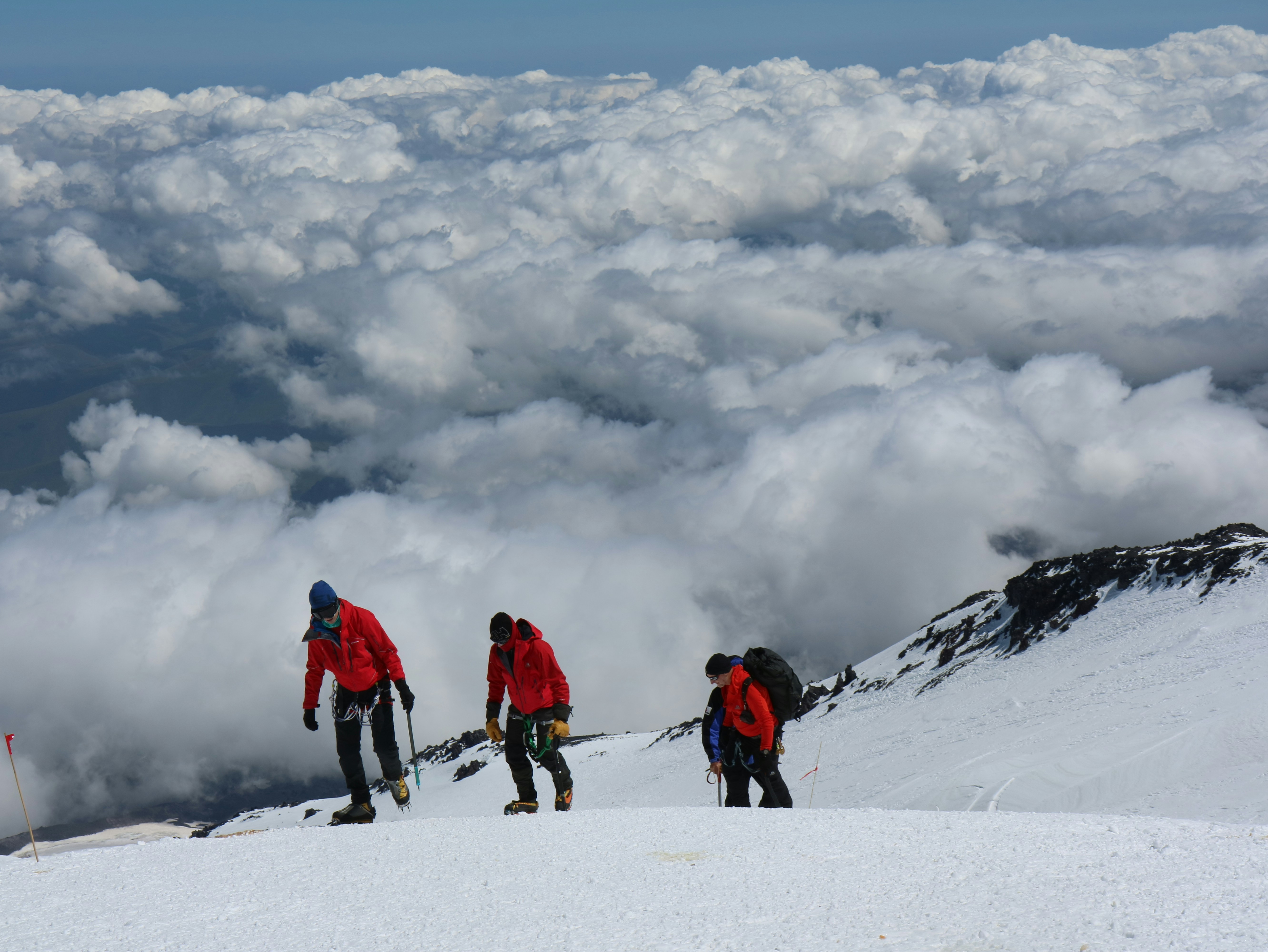 Climbers ascending Mount Kilimanjaro above the cloud layer