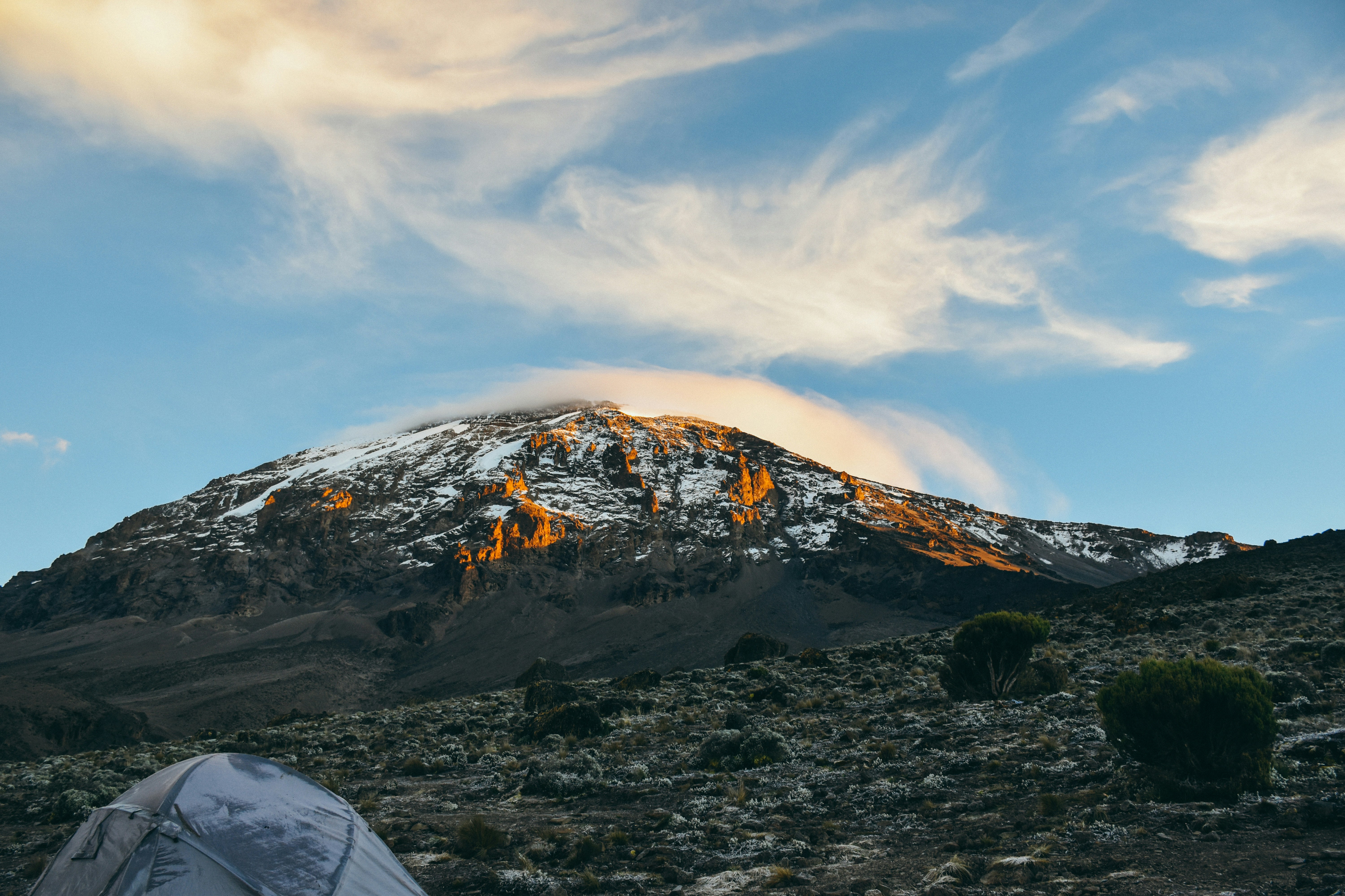 A camp beneath Mount Kilimanjaro at sunset