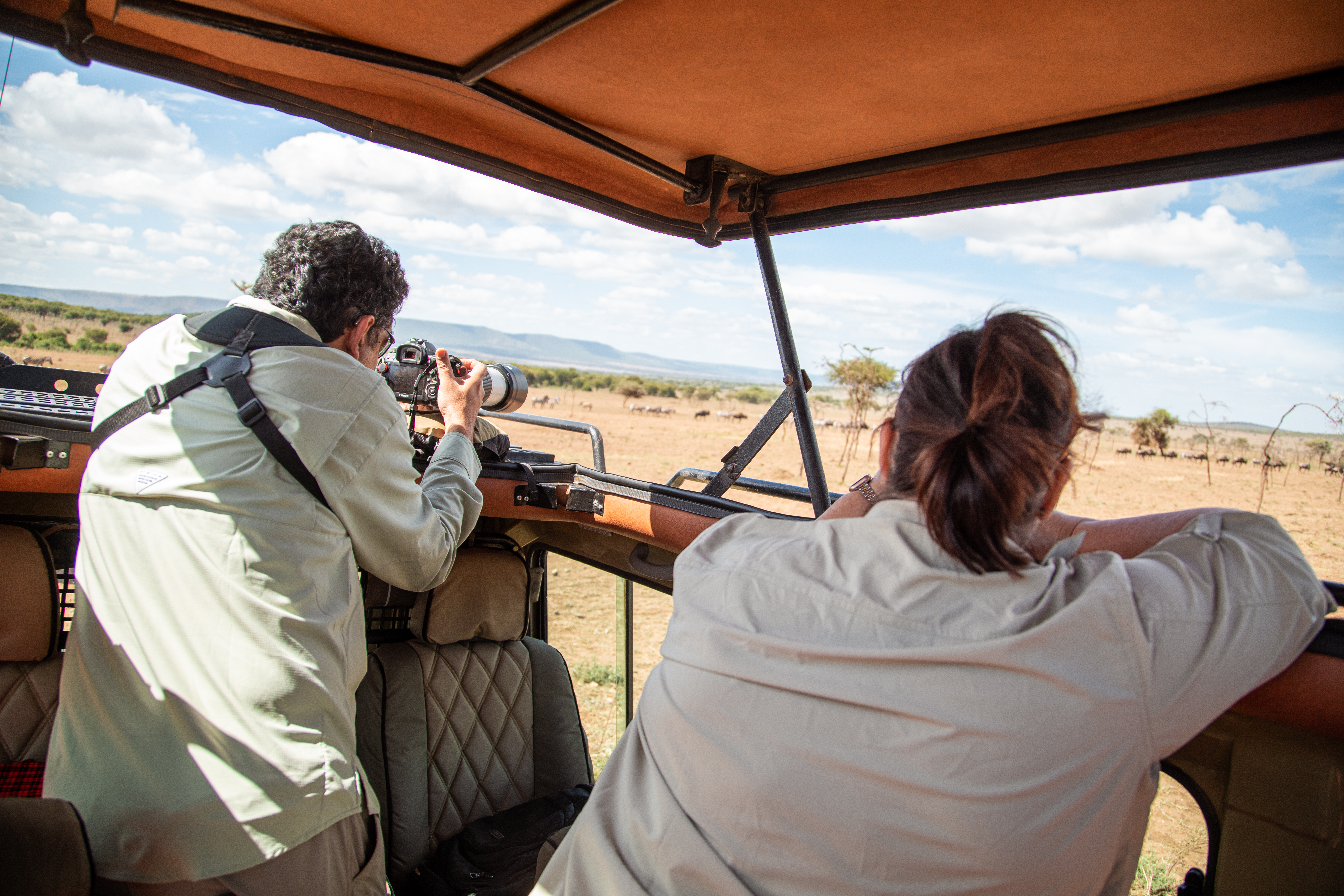 Safari photographer capturing the wilderness from an Excellent Guides vehicle