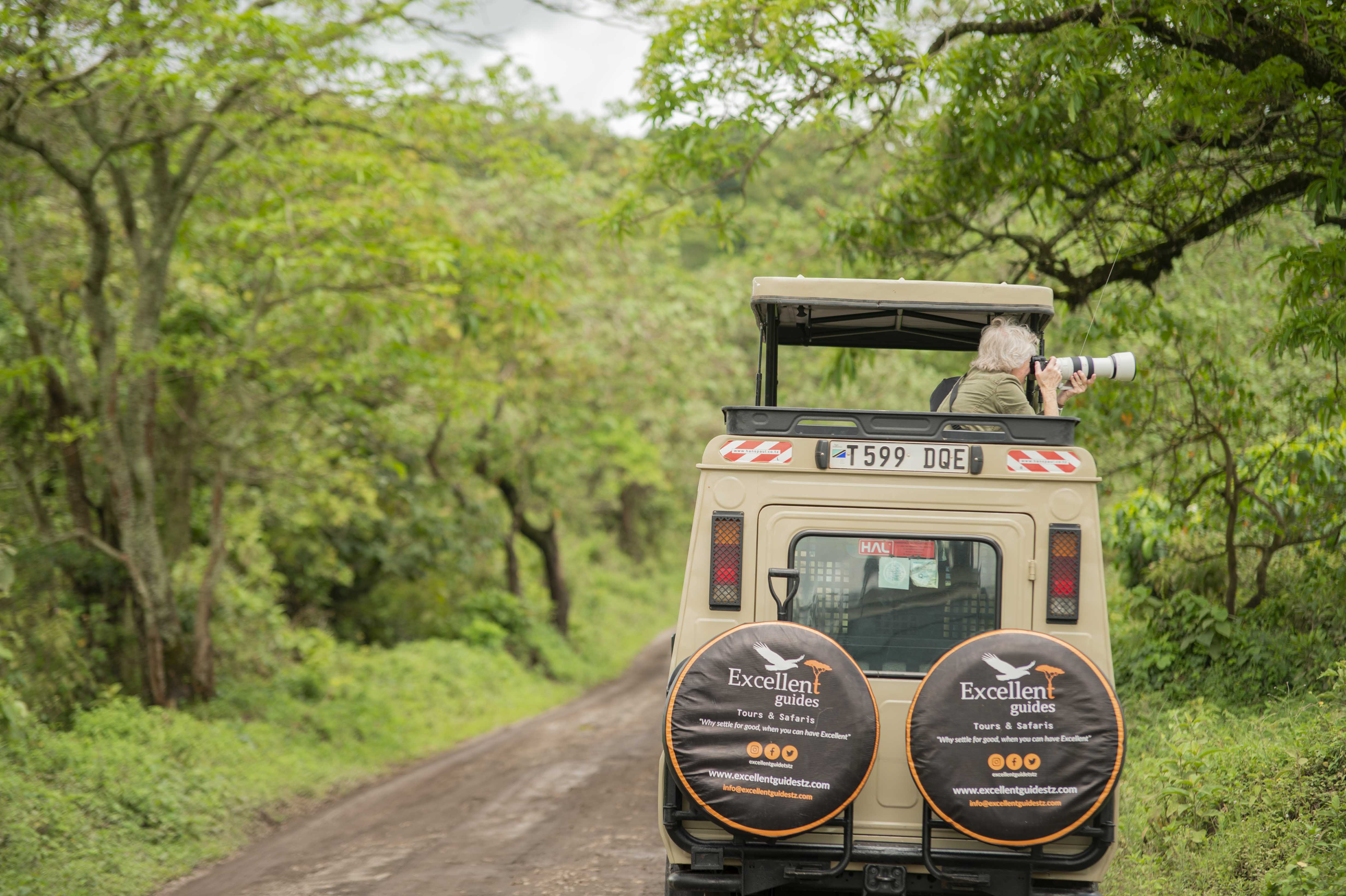 Guest using a camera from an Excellent Guides pop-up roof safari vehicle