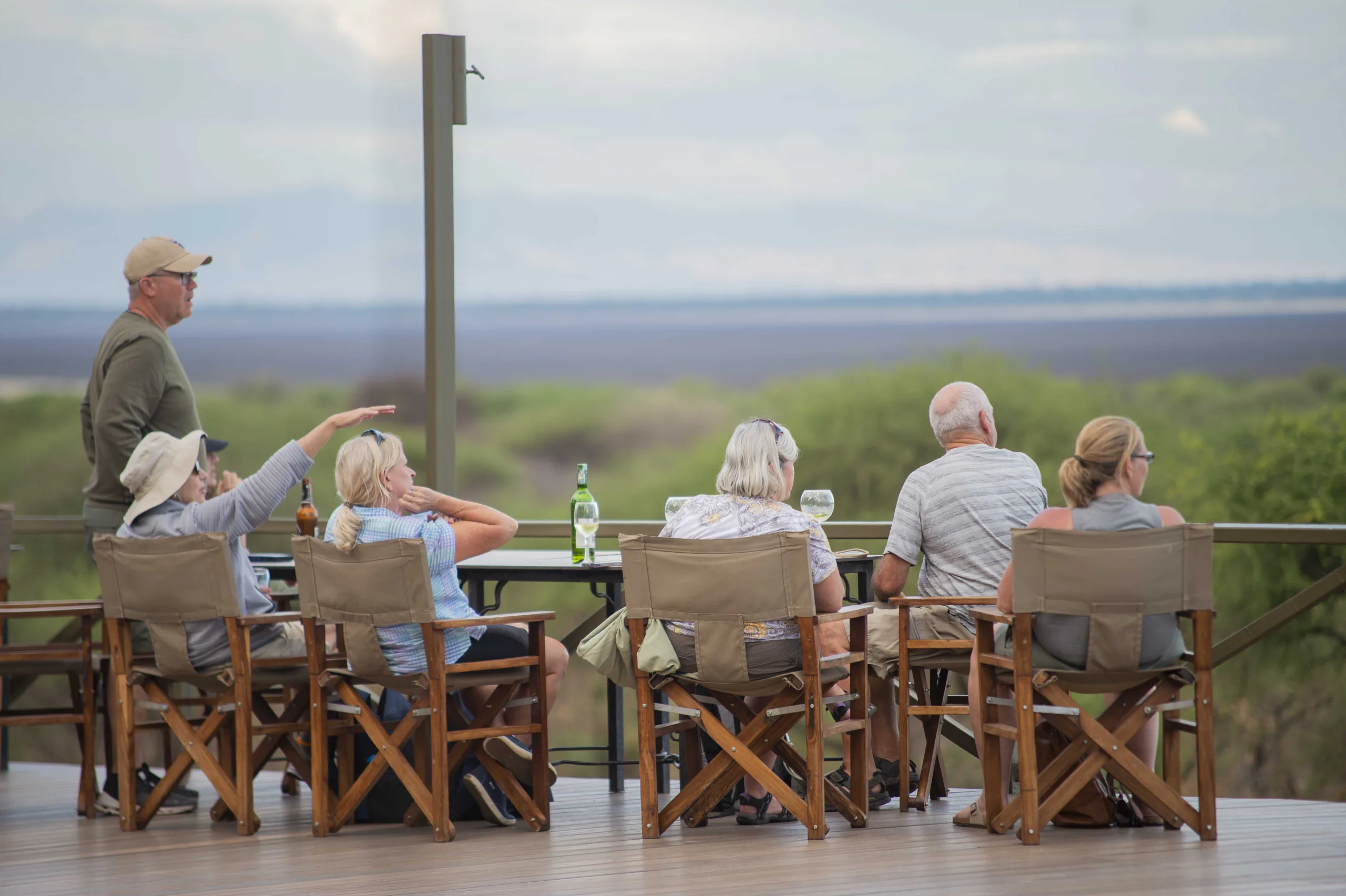 Travelers observing elephants from a safari vehicle